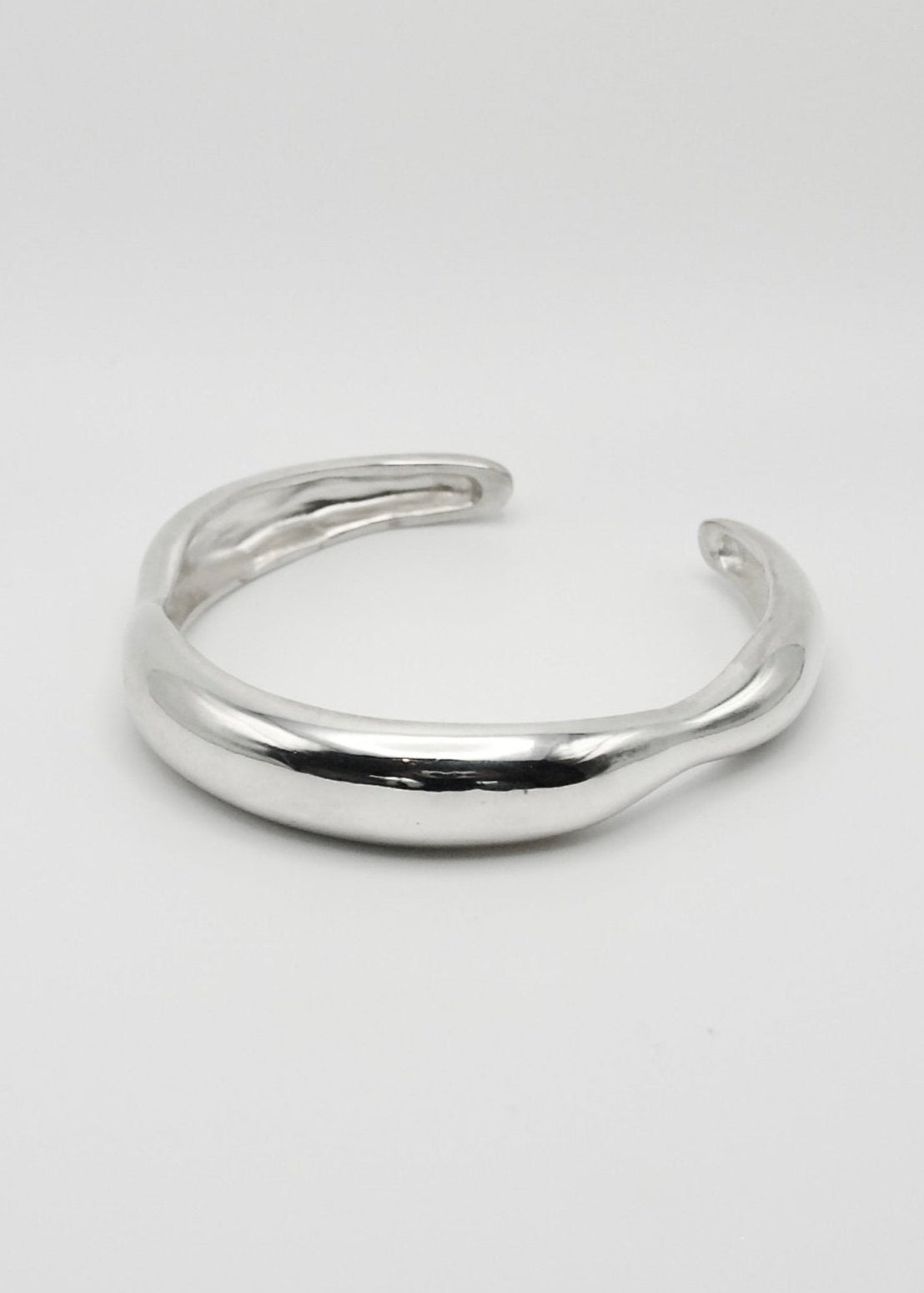 Agnes Bracelet displayed on a neutral background, highlighting its sleek sterling silver design with a mirror-polished finish.