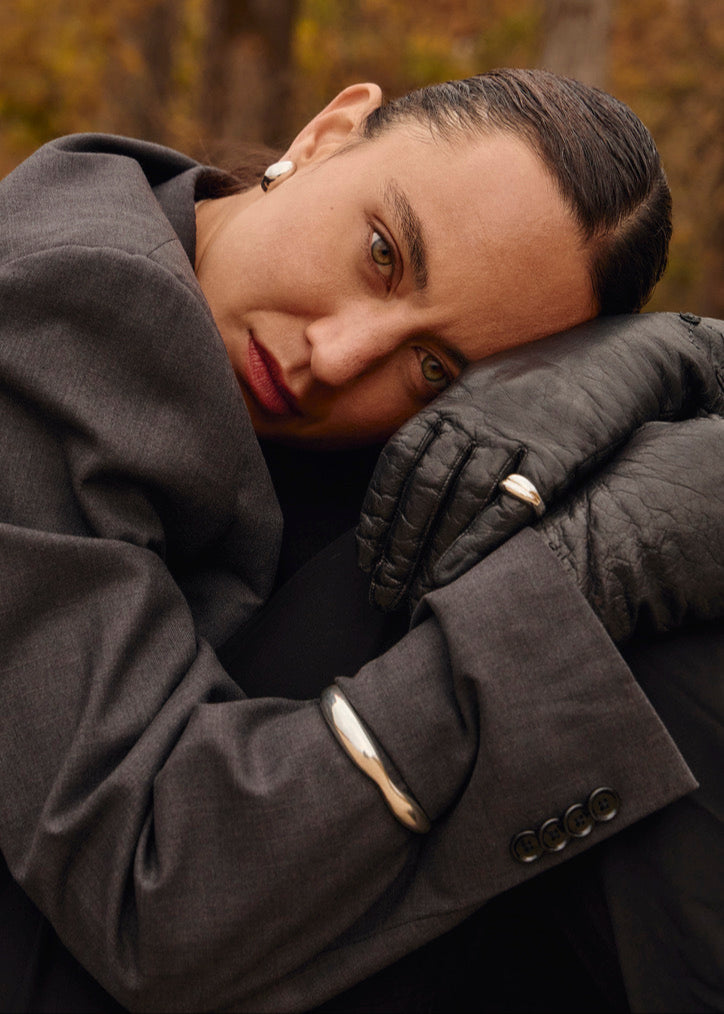 Close-up of a model's wrist wearing the Agnes Bracelet in nature, emphasising its elegant sculptured cuff style and comfortable fit.