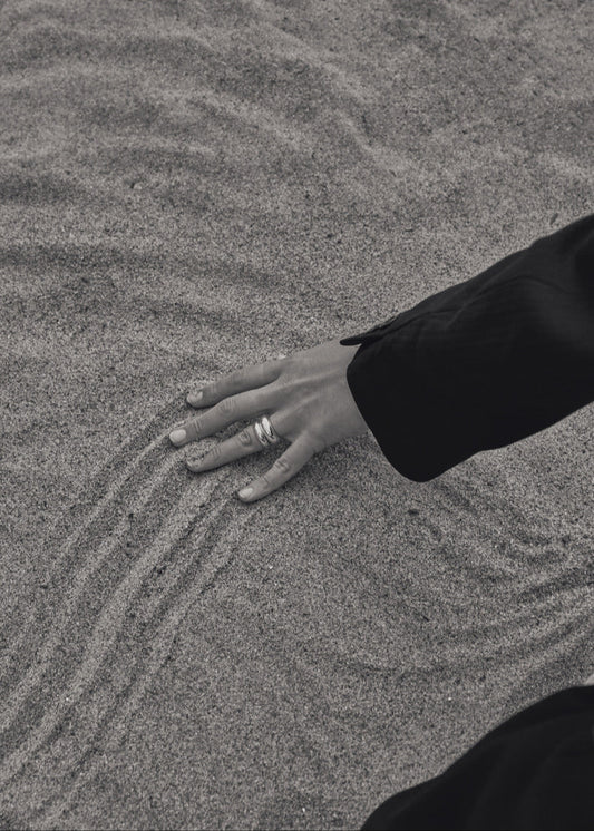 Close-up of a model's finger wearing the Jooni Ring with the Nilou ring, emphasizing its stackable design and comfortable fit.