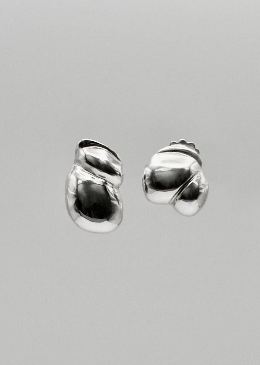 Camille Earrings displayed on a neutral background, highlighting their sculptural design and mirror-polished sterling silver finish.