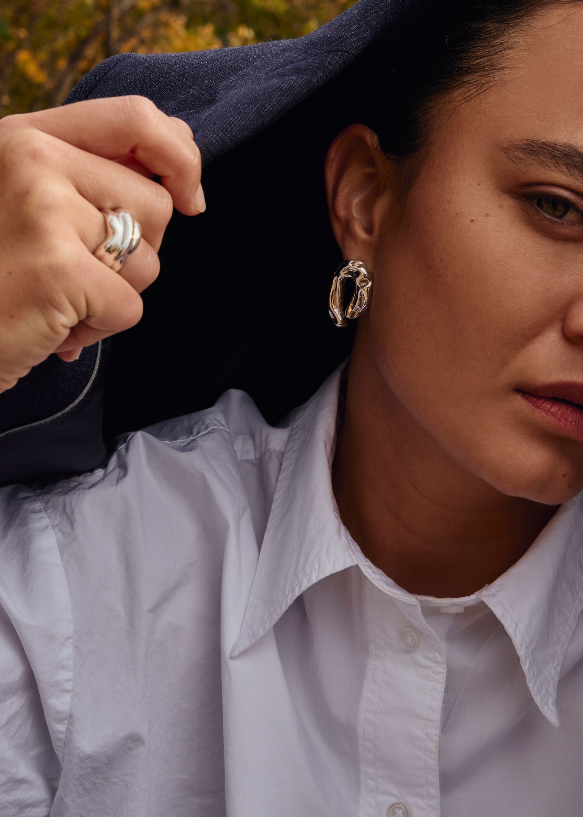 Side view of sculptural silver Ragne Earrings, handmade with a textured finish