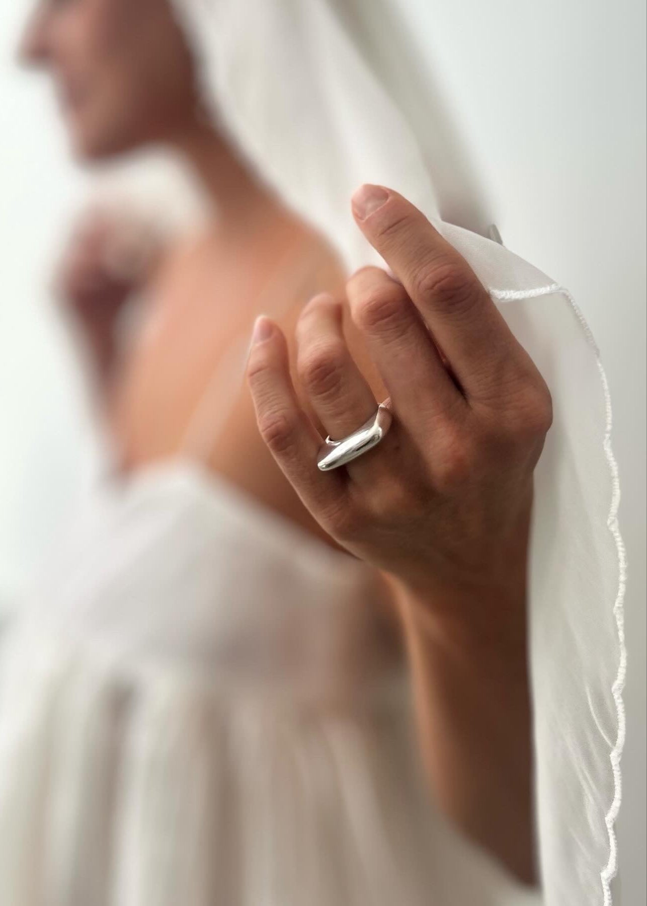 Close-up of a model's hand wearing the Dagmar Ring, emphasizing its statement-making presence and comfortable fit.