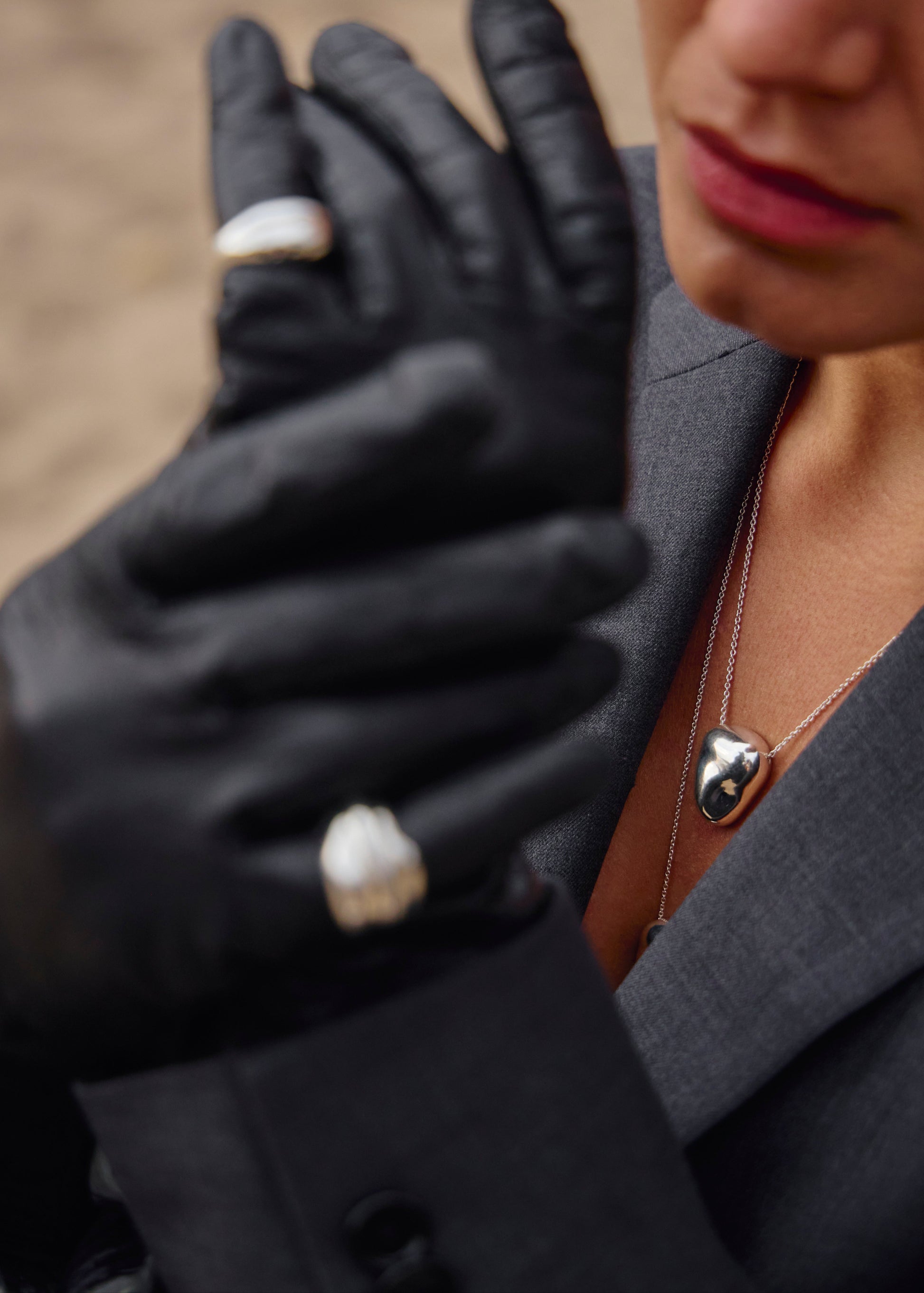 Close-up of the Heart Pendant worn on a model, emphasising its design and how it complements various styles and really brings out the contemporary design.