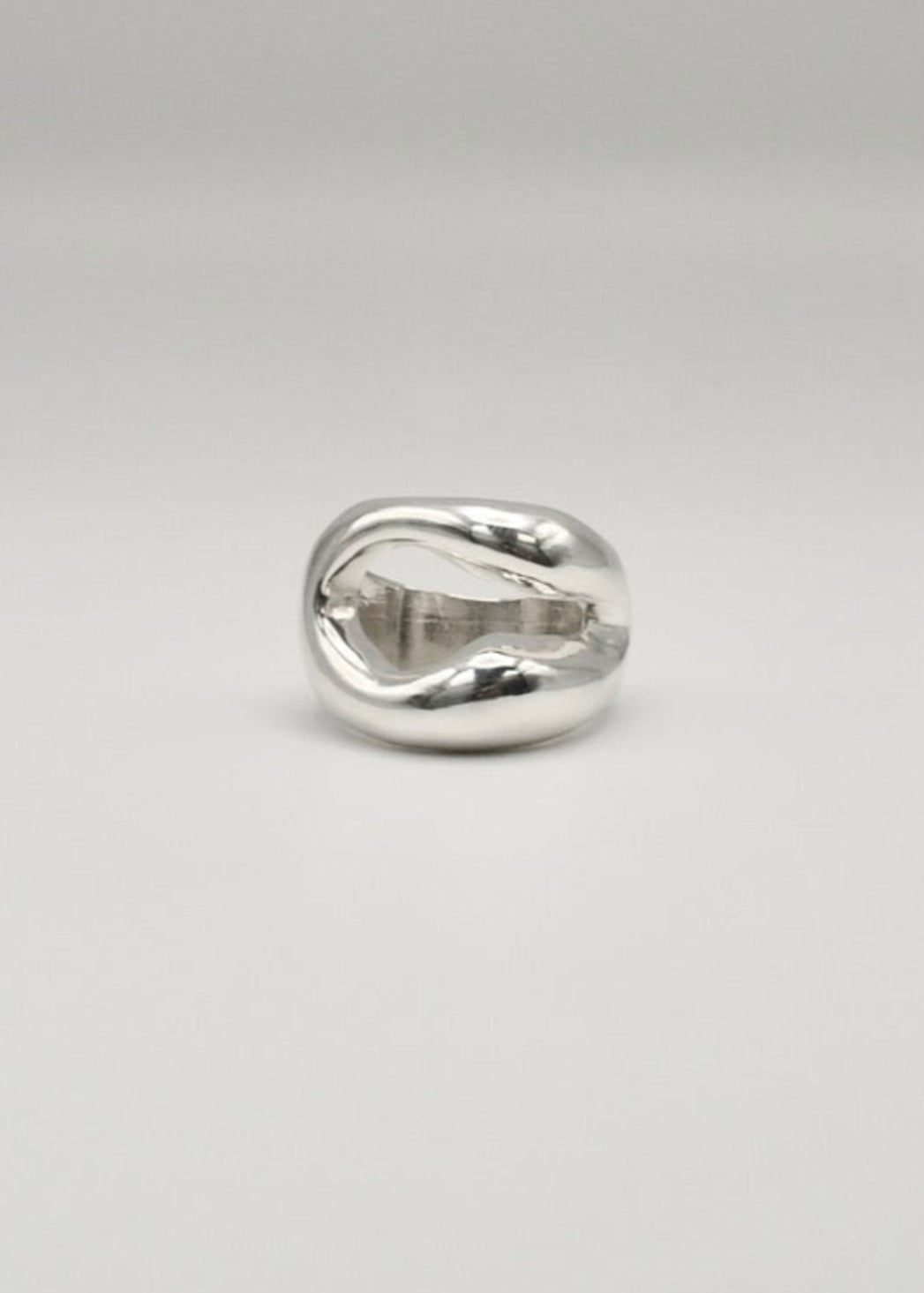 Eliza Ring displayed on a neutral background, highlighting its organic shape and central opening, crafted in 925 sterling silver.