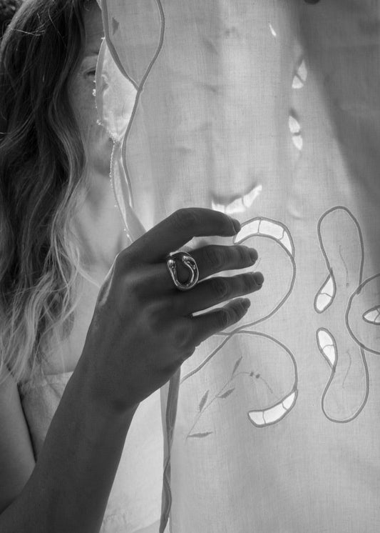 Close-up of a model's hand wearing the Eliza Ring, emphasising its unique design and comfortable fit.