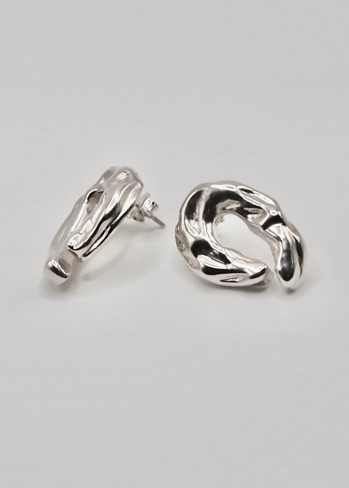 Detailed view of the Ragna Earrings, focusing on their intricate craftsmanship and the reflective quality of the 925 sterling silver.