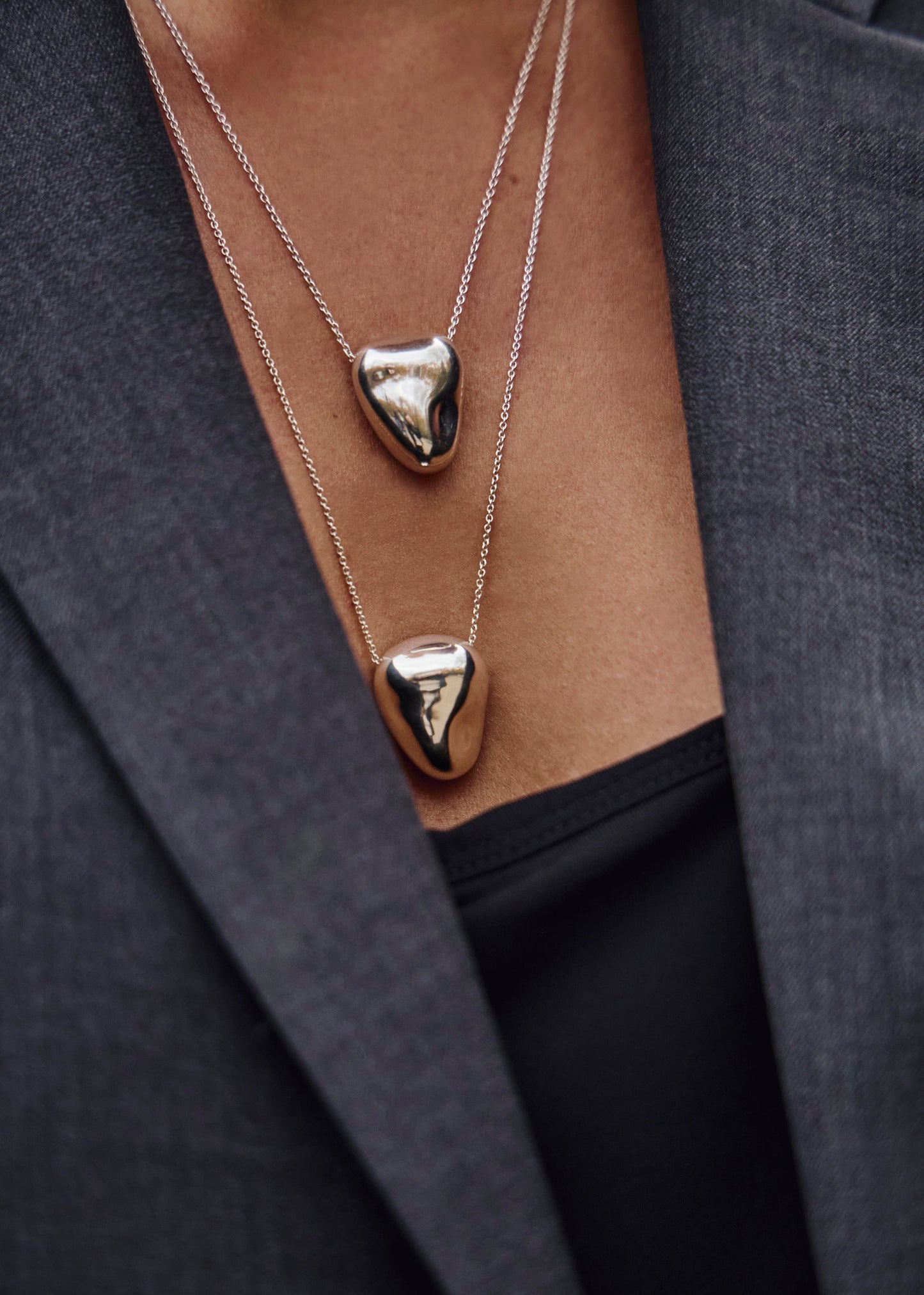 Close-up of the Heart Pendant worn on a model, emphasizing its design and how it complements various styles.