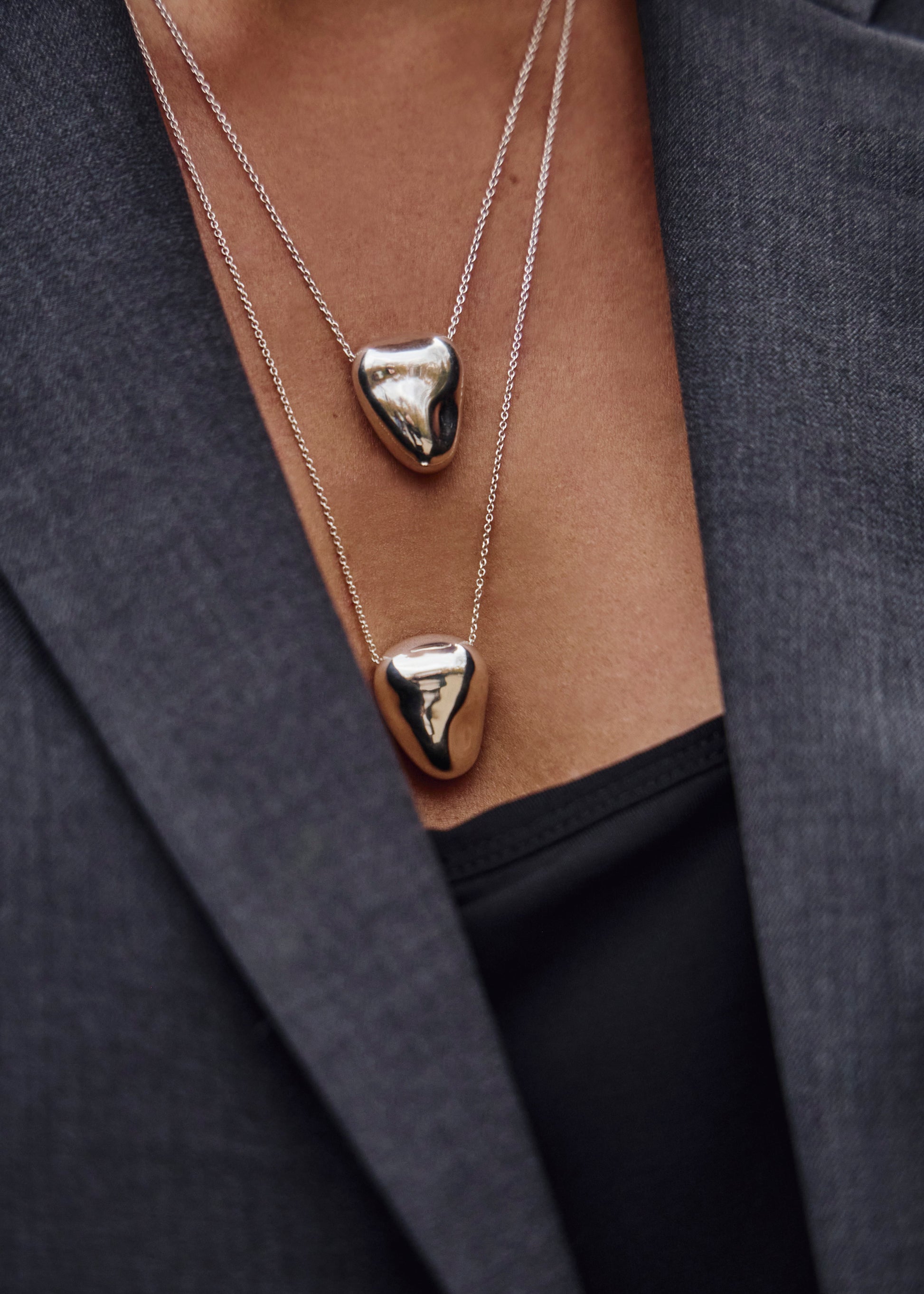Close-up of the Heart Pendant worn on a model, emphasizing its design and how it complements various styles.