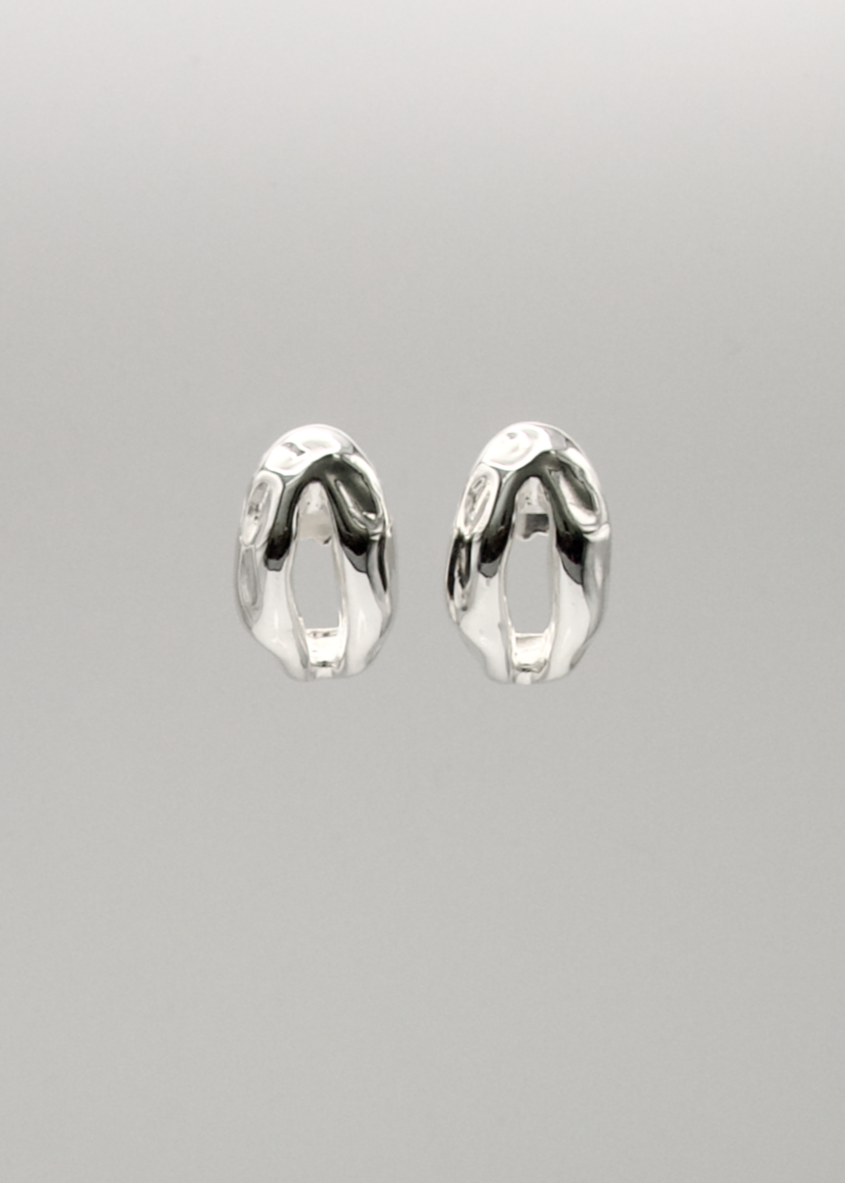 Sculptural silver earrings designed for minimalist elegance, perfect for everyday wear or special occasions.