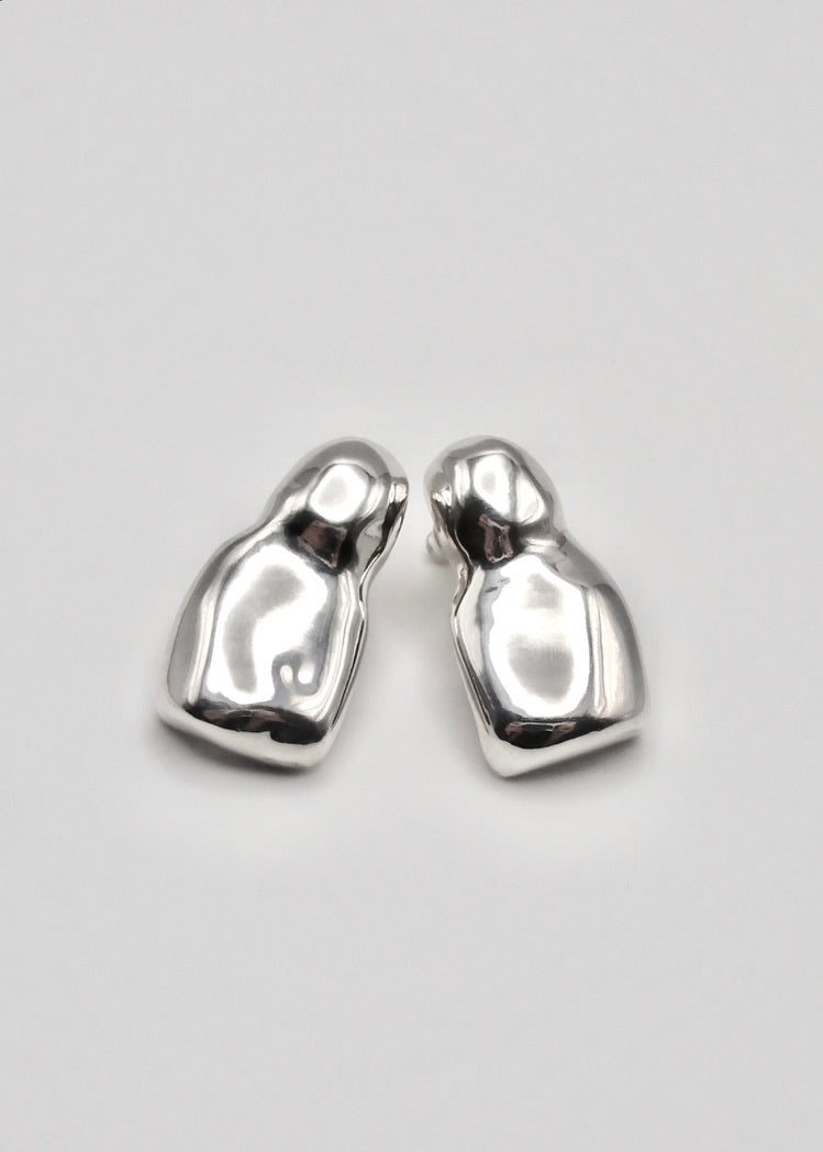 Luna Earrings displayed on a neutral background, highlighting their elegant drop design and mirror-polished sterling silver finish. Shape is childish and very organic which highlight the mirror polishing.