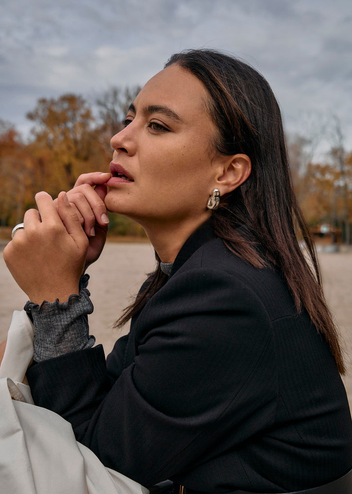 Close-up of a model wearing the Luna Earrings, emphasizing their graceful movement and how they complement various styles.