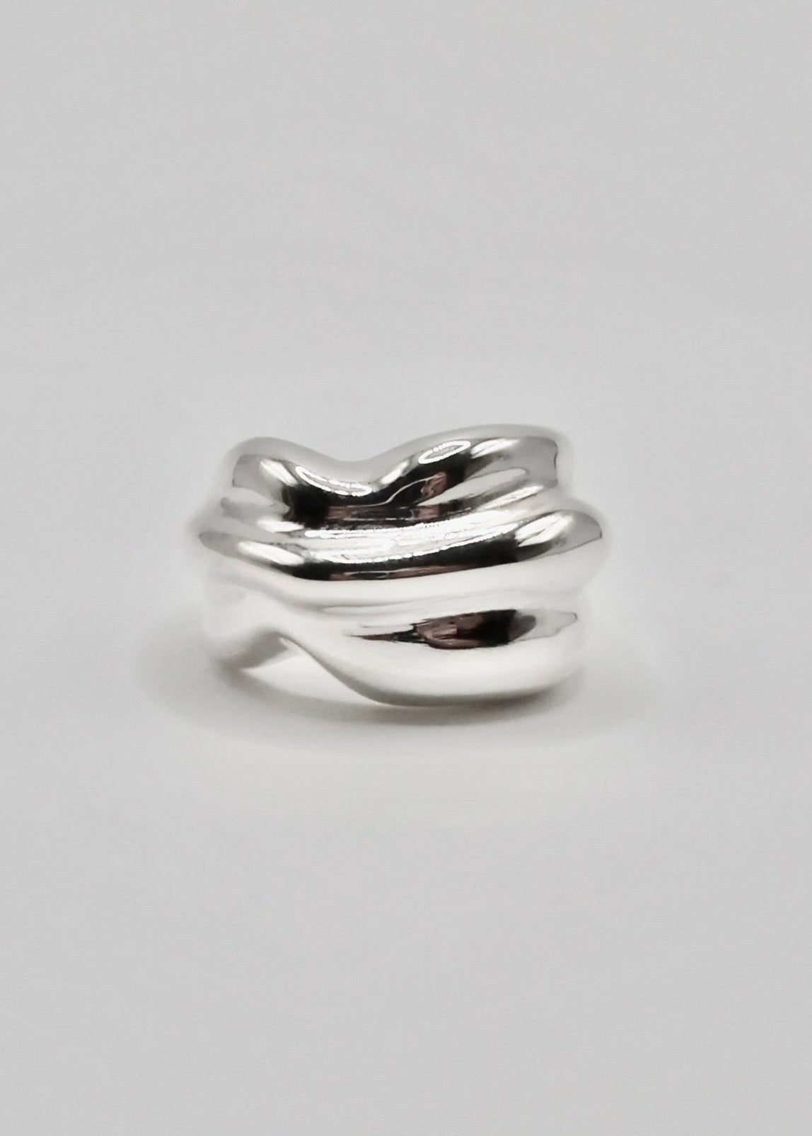 Marianne Ring displayed on a neutral background, highlighting its bold, sculptural voluminous design and mirror-polished sterling silver finish.
