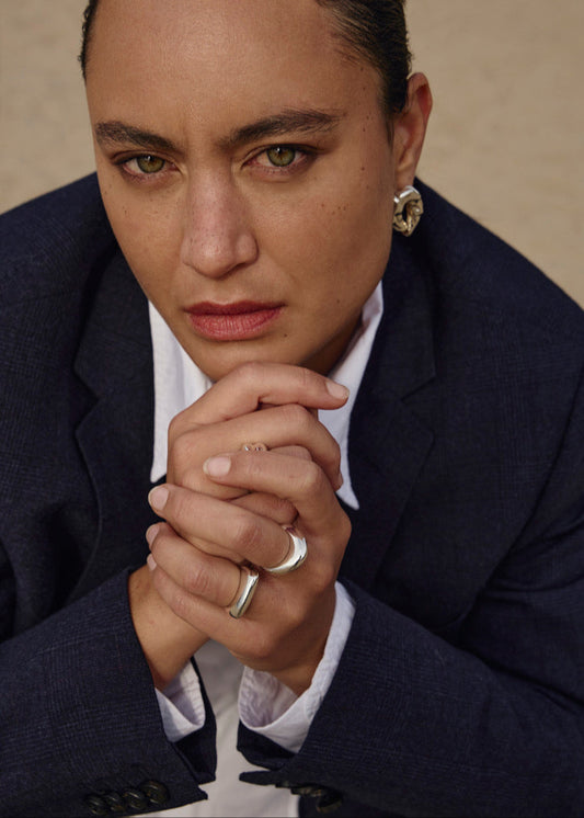 Close-up of a model's finger wearing the Astrid Ring, emphasizing its elegant simplicity and comfortable fit.