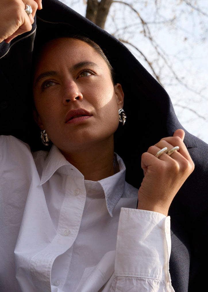 Close-up of a model wearing the Ragna Earrings, emphasizing their bold design and how they complement contemporary styles.