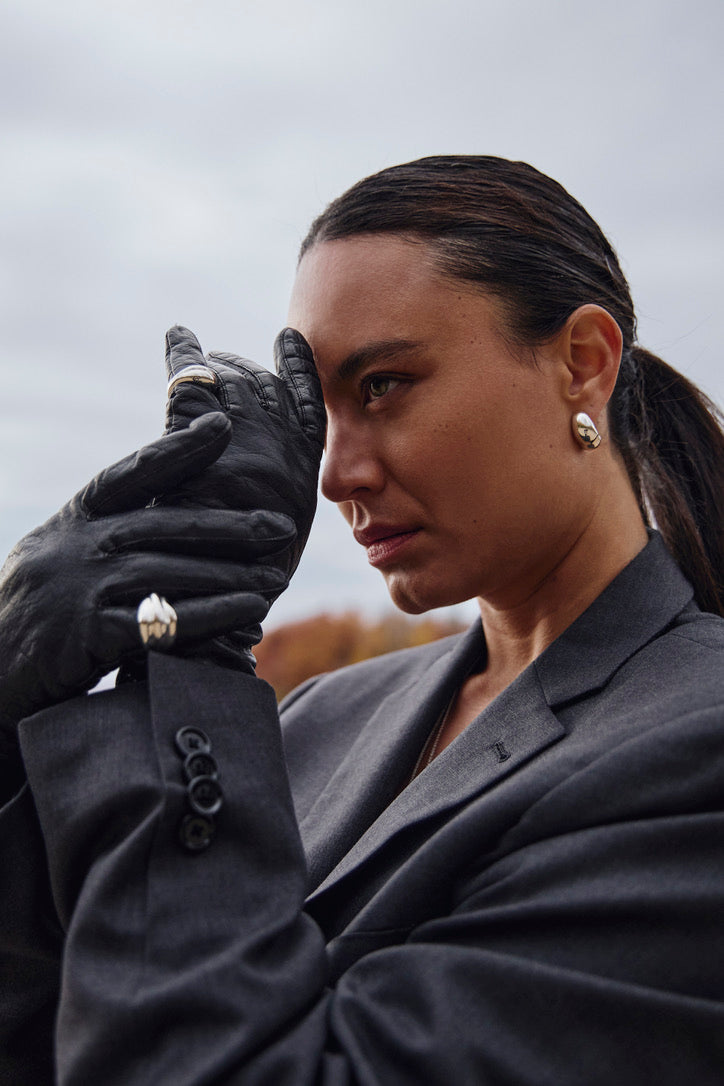 Close-up of a model wearing the Sigrid Earrings, emphasizing their bold hoop design and how they complement contemporary styles.