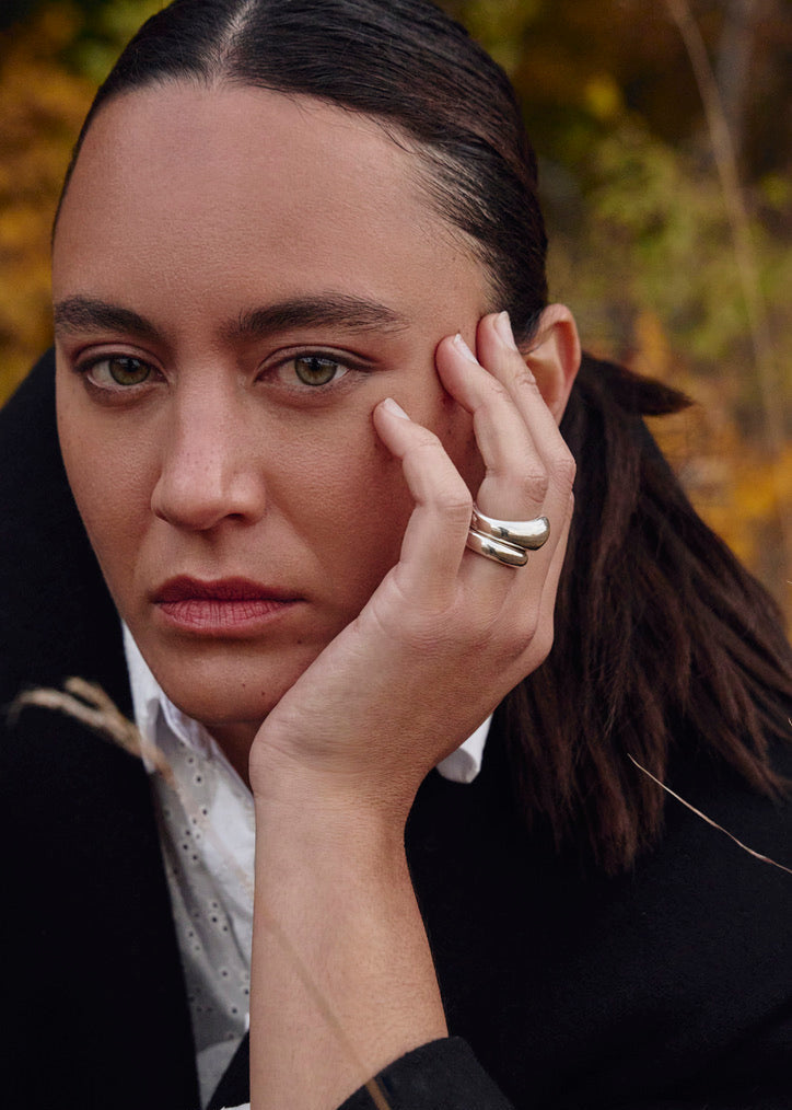 Close-up of a model's finger wearing the Jooni Ring with the Ingrid ring, emphasising its stackable design and comfortable fit.