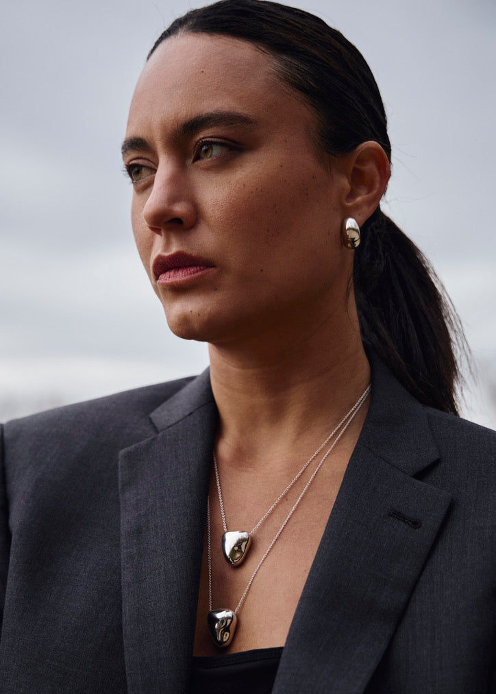 Close-up of a model wearing the Sigrid Earrings, emphasizing their bold hoop design and how they complement contemporary styles.