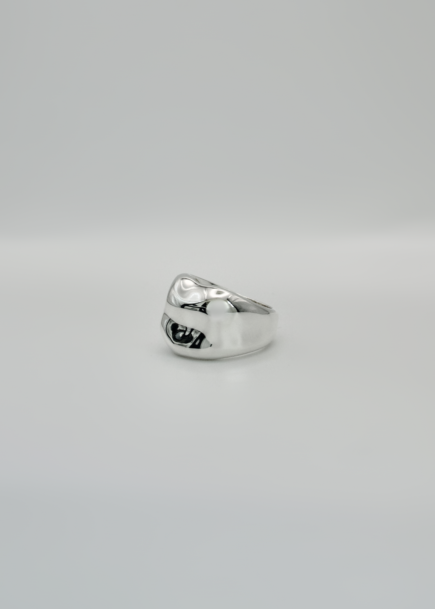 Silver ring on a light gray background
