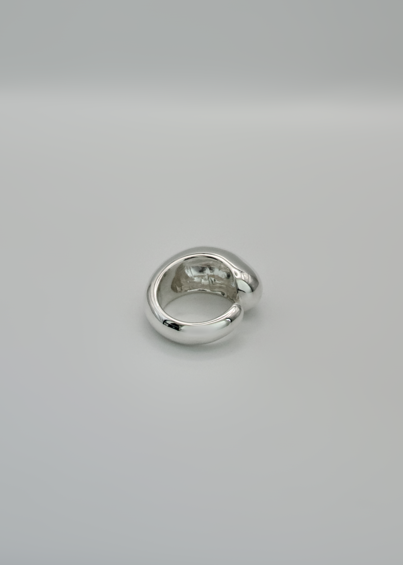Silver ring on a light gray background
