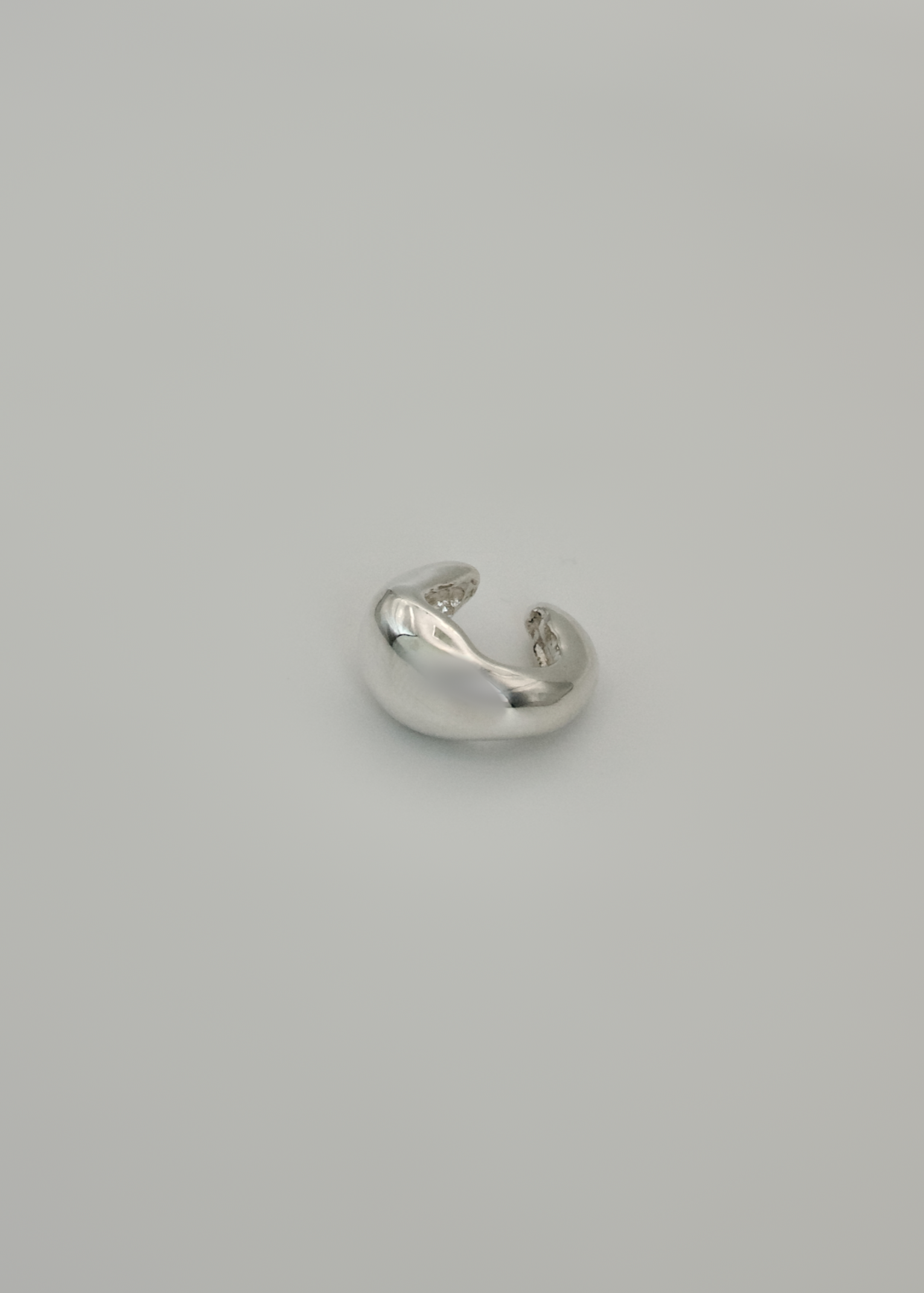 Silver earring cuff ( wide option) on a light gray background
