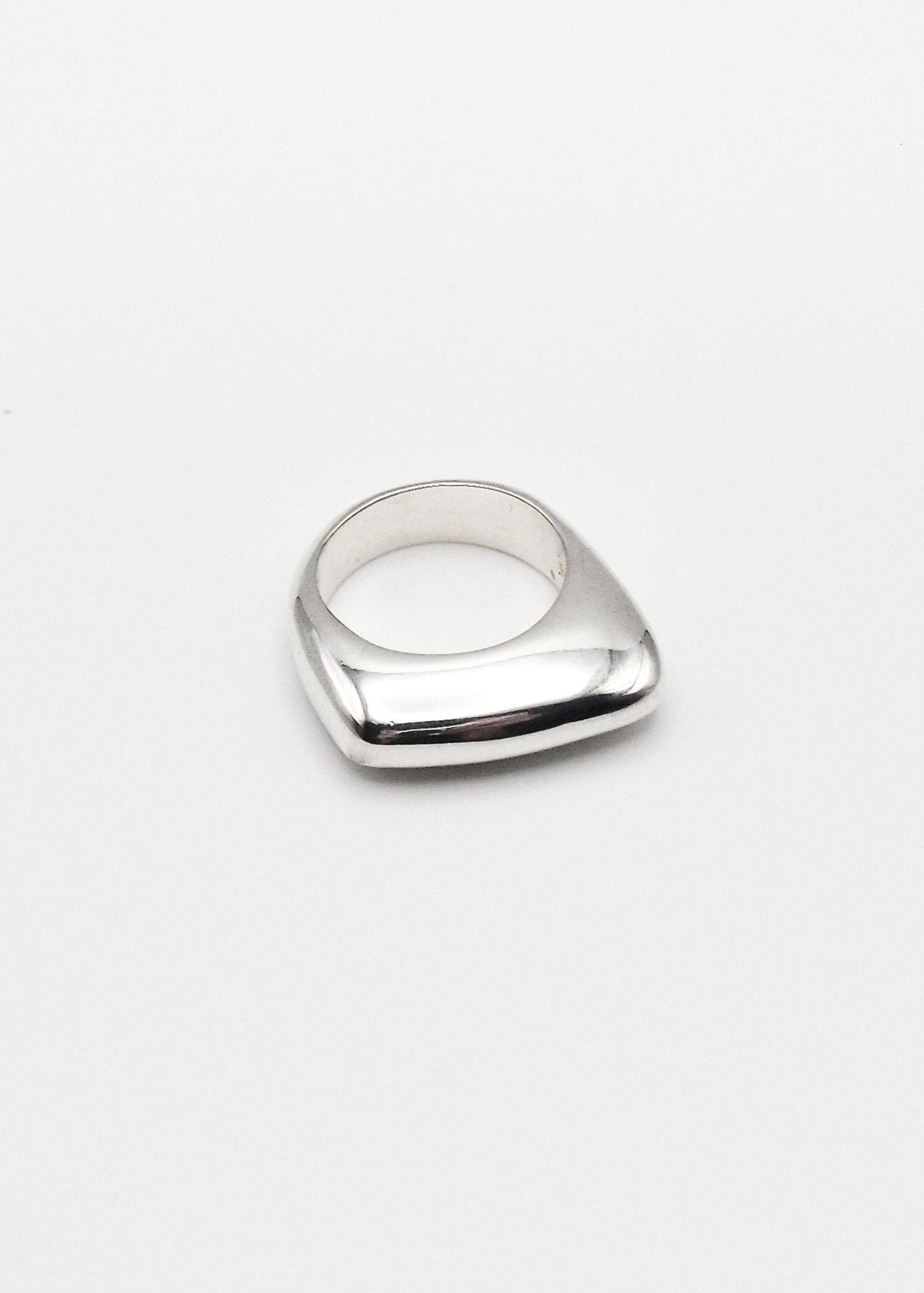 Dagmar Ring displayed on a neutral background, highlighting its bold design and mirror-polished sterling silver finish.