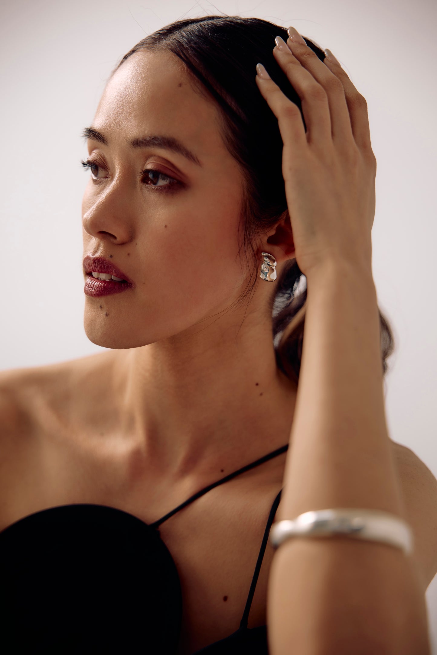 Model wearing the Camille earrrings , sculptured and casted in sterling silver from SÉOLA Atelier