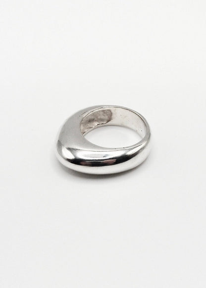 Astrid Ring displayed on a neutral background, highlighting its sleek design and mirror-polished sterling silver finish.
