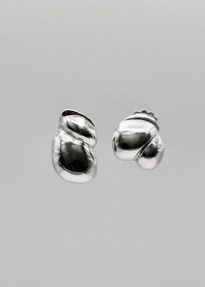 Camille Earrings displayed on a neutral background, highlighting their sculptural design and mirror-polished sterling silver finish.​

