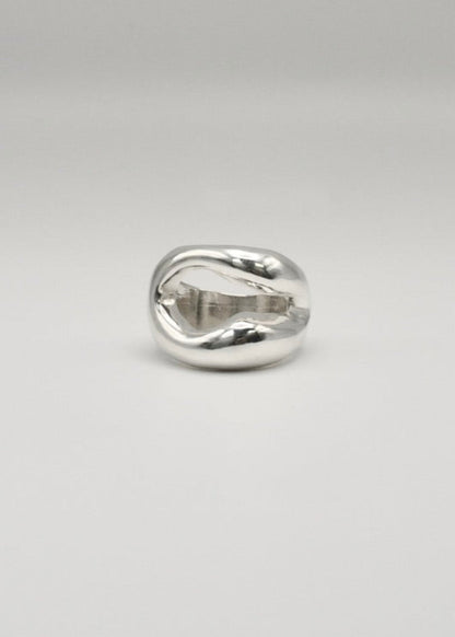 Eliza Ring displayed on a neutral background, highlighting its organic shape and central opening, crafted in 925 sterling silver.​