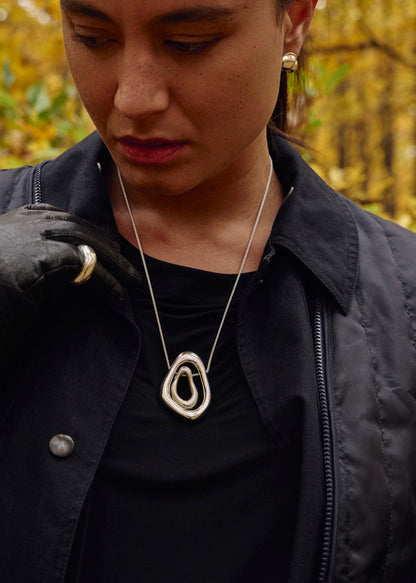 Close-up of a model wearing the Camille Earrings, emphasizing their unique shape and how they complement various styles and integrate with all the other pieces in the collection