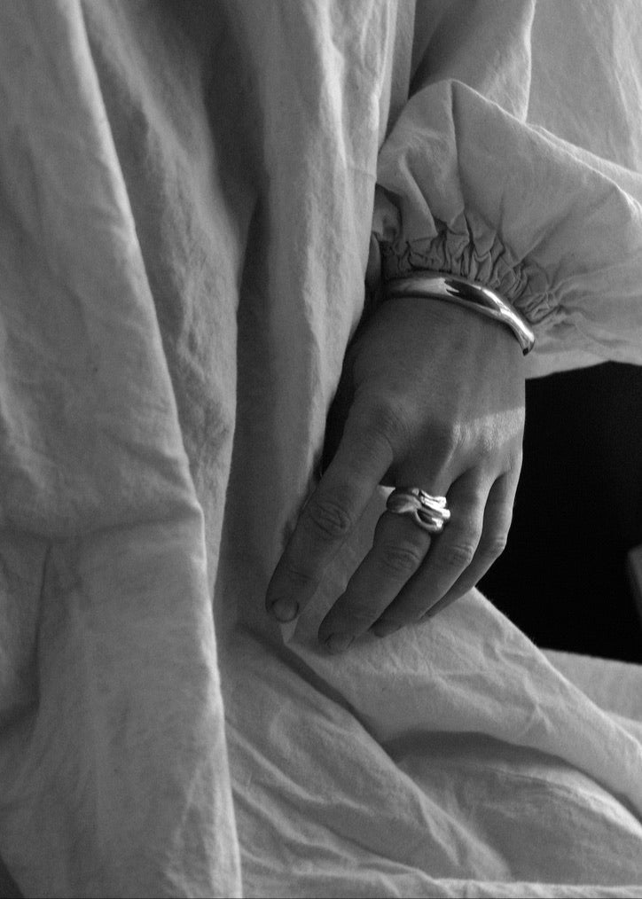 Close-up of a model's hand wearing the Marianne Ring, emphasising its statement-making presence and comfortable fit.​ 

