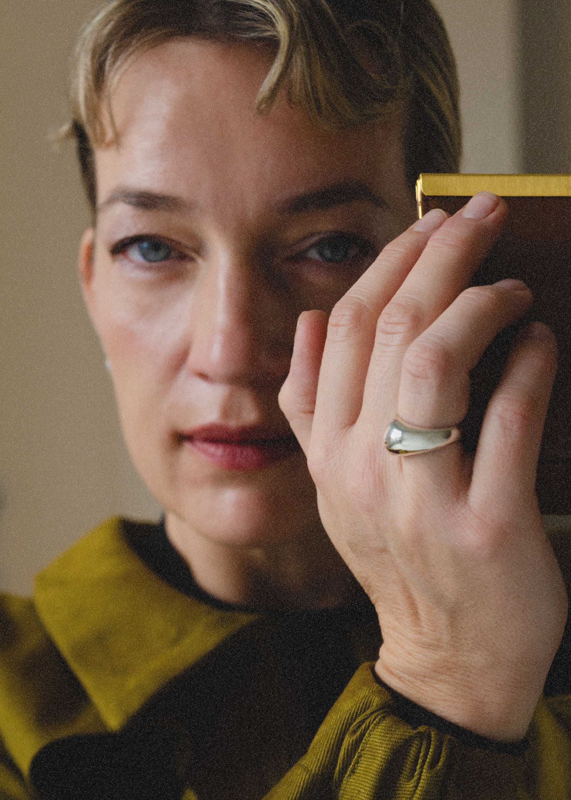 Model wearing the ingird ring in sculptured sterling silver.Close-up of a model's finger wearing the Ingrid Ring, emphasizing its sculptural form and comfortable fit.