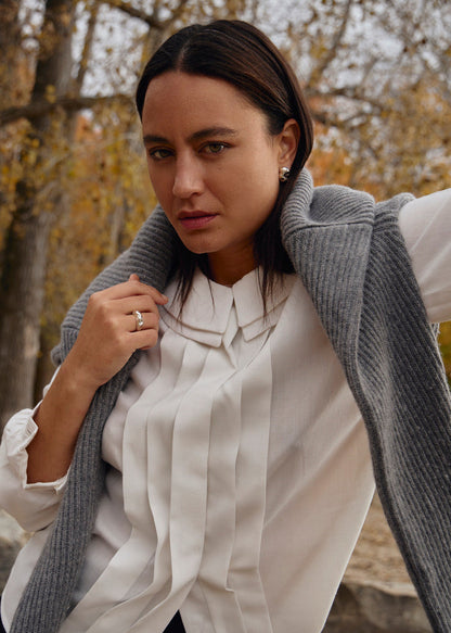 The Esther Ring, measuring 5.5 mm in width and weighing approximately 6.2 grams, is part of SÉOLA Atelier's trio of sister rings, alongside the Astrid and Dagmar rings. Handcrafted from 925 sterling silver with a textured surface and mirror-polished finish, it offers a bold yet refined aesthetic.