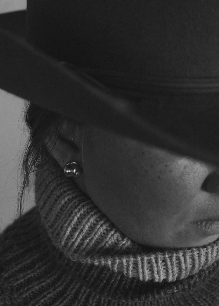 Close-up of a model wearing the Camille Earrings, emphasizing their unique different shape and how they complement various styles.