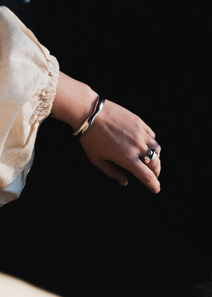 Close-up of a model's wrist wearing the Agnes Bracelet, emphasising its elegant cuff style and comfortable fit.