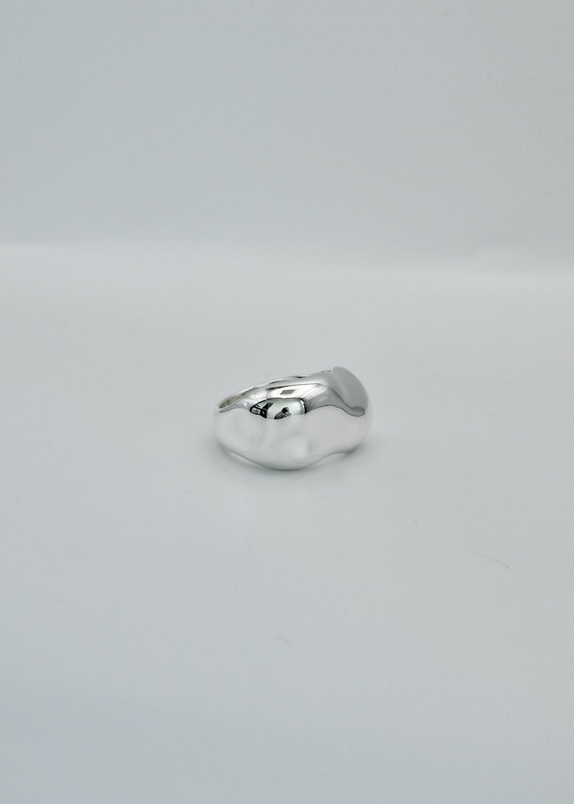Silver ring on a light gray background
