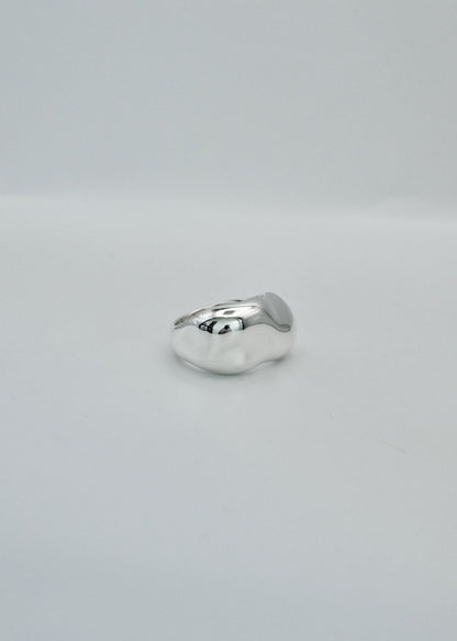 Silver ring on a light gray background