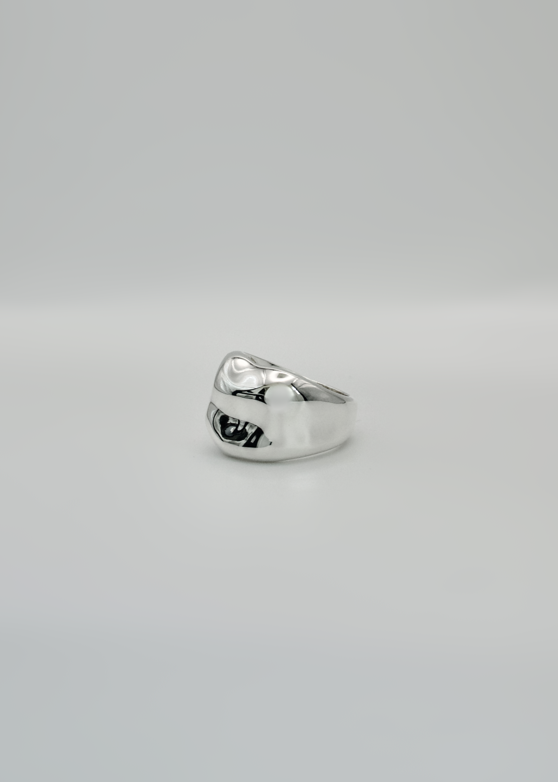 Silver ring on a light gray background
