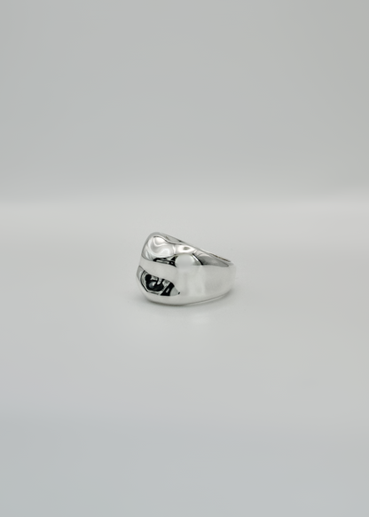 Silver ring on a light gray background