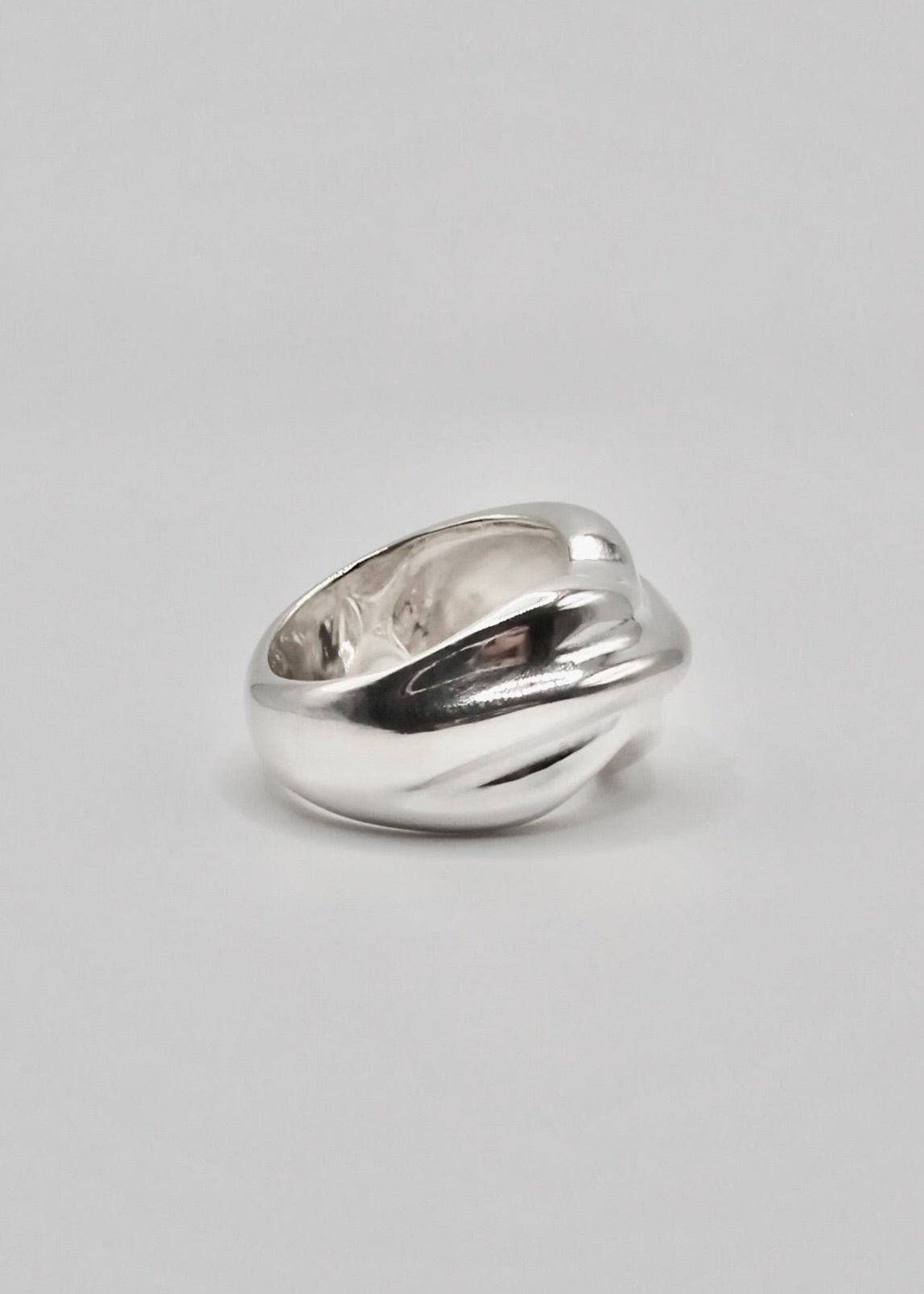Detailed side view of the Marianne Ring, focusing on its intricate craftsmanship and the reflective quality of the 925 sterling silver.