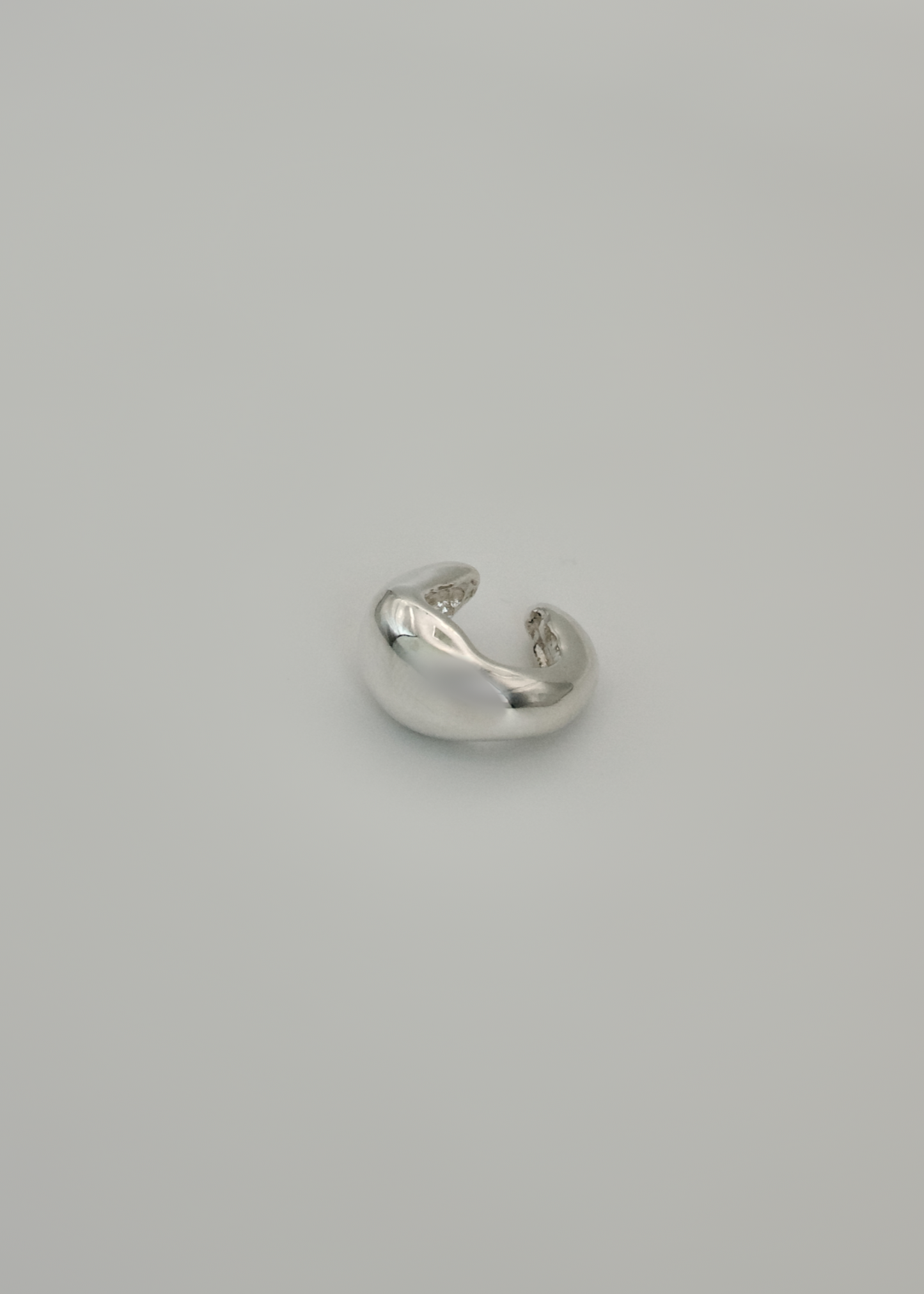 Silver earring cuff ( wide option) on a light gray background